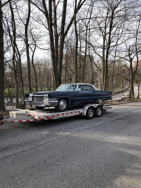 Classic blue car on a tow